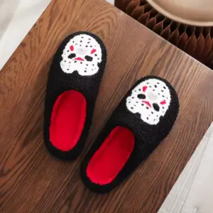 Horror Mask Plush Slippers – Embroidered Skull Non-Slip Cozy House Shoes for Men & Women on table