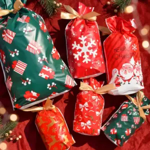 Santa Snowflake Drawstring Gift Bags for Treats & Holiday Favors lifestyle-flatlay